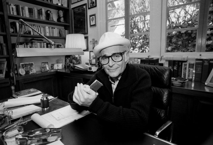 Norman Lear sitting at his desk