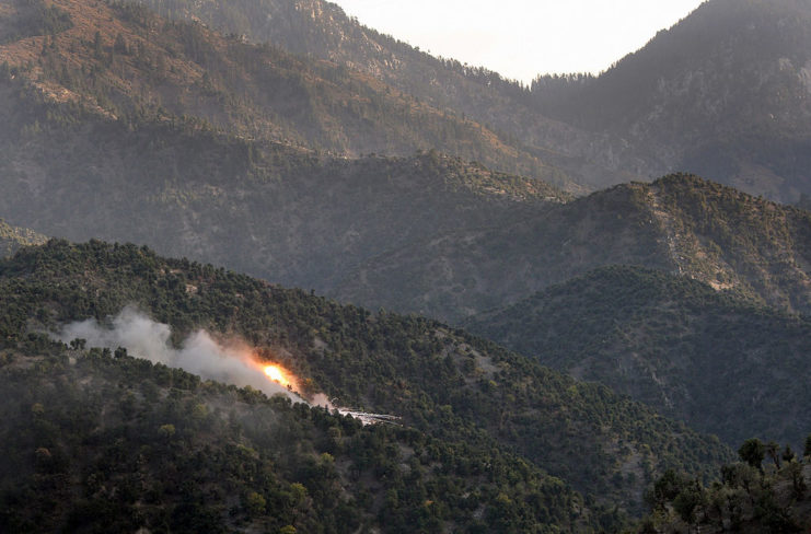 Aerial view of a Taliban position shrouded by flames in the Korengal Valley