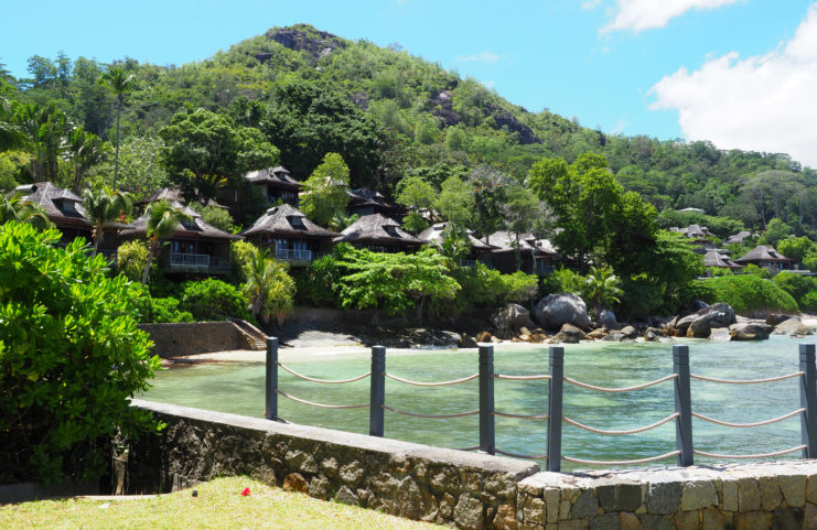 Huts positioned along the shore of a beach