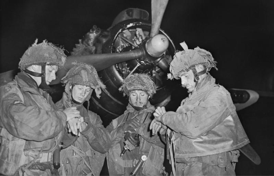 Four paratroopers standing in front of an aircraft