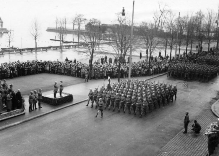 Aerial view of soldiers marching together down a street