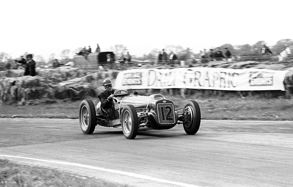 Tony Rolt driving a race car around a track