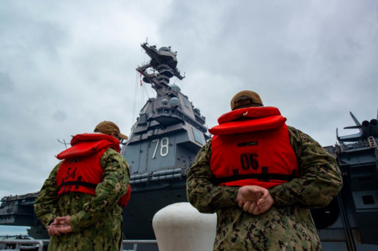 Two US Navy sailors wearing life jackets