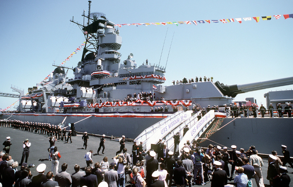 Crowd gathered beside a docked USS Missouri (BB-63)