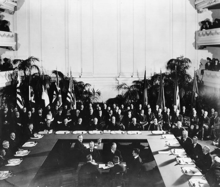 Government officials standing around a large table