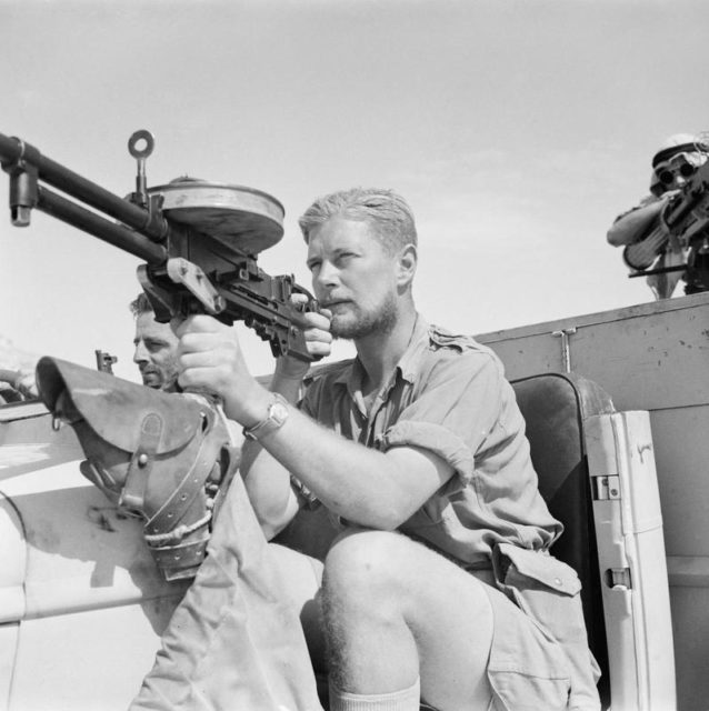 Long Range Desert Group (LRDG) member manning a machine gun on the back of a Chevrolet 30cwt