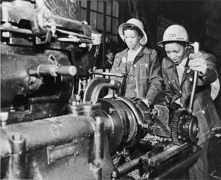 Martha Bryant and Eulalie Hampden operating a bolt-cutting machine