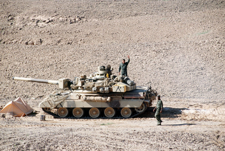 French soldiers standing around an AMX-30B2 in the desert