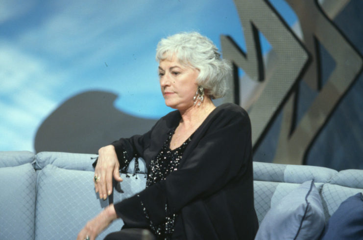 Bea Arthur sitting on a couch