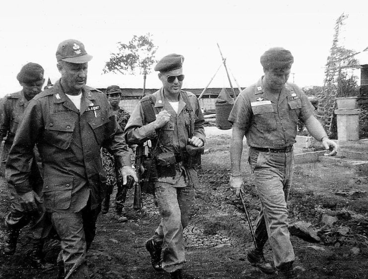 Donald Blackburn walking with other military officials in a MACV-SOG field location