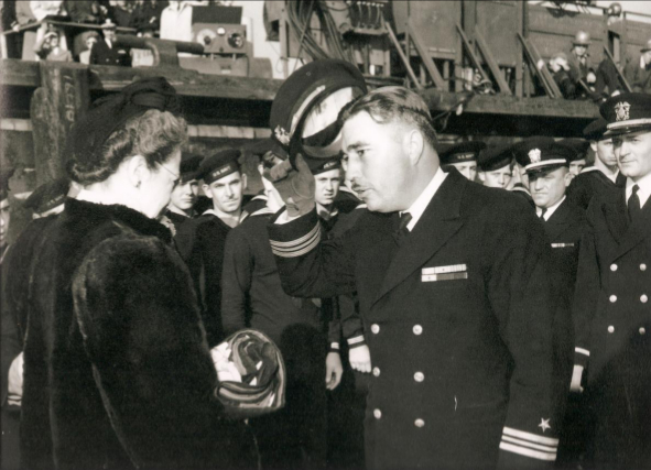 Ernest Evans lifting his cap in respect at the commissioning ceremony for the USS Johnston (DD-557)