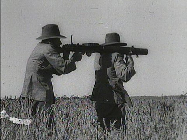 Two men aiming a Lewis Gun