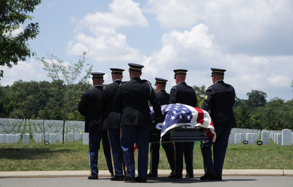 Servicemen carrying a flag-draped coffin