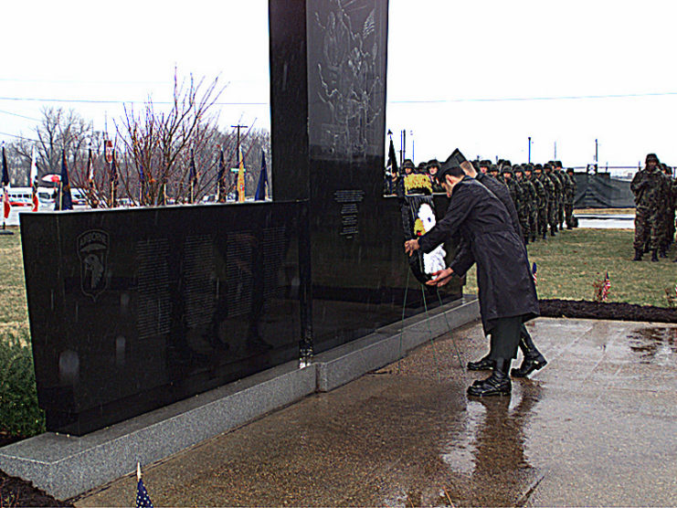 Lt. Col. Sidney McMannis and Command Sgt. Maj. Raymond Rodriquez laying a wreath in front of a memorial at Fort Campbell, Kentucky