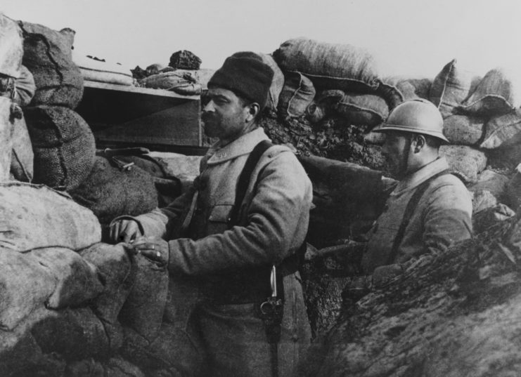 Two soldiers standing in a trench