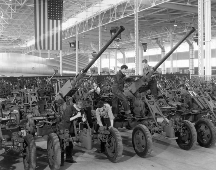 Worker constructing 40 mm anti-aircraft guns in a factory