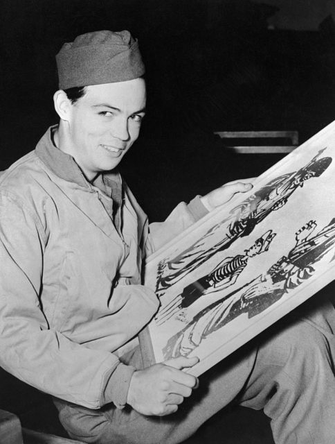 Bill Mauldin holding a framed photo of one of his cartoons