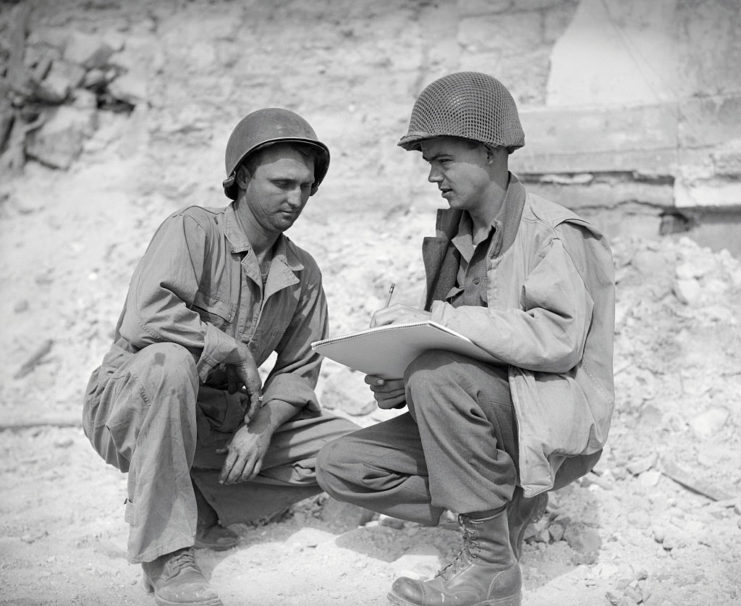 Robert L. Bowman sitting with Bill Mauldin as he sketches