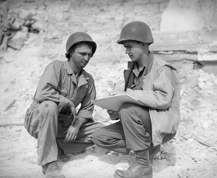 Robert L. Bowman sitting with Bill Mauldin as he sketches