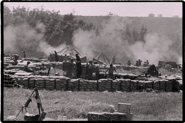 Members of the 4th Infantry Division standing among sandbags