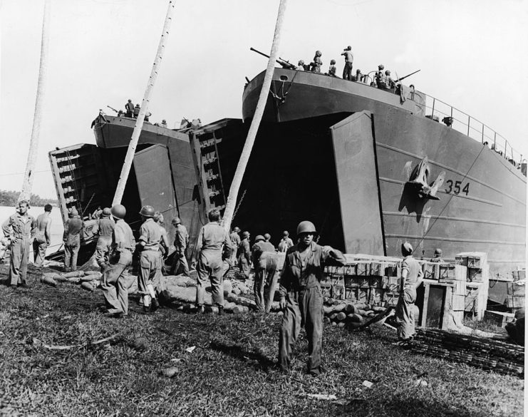 American sailors and Marines unloading supplies from a Landing Ship, Tank (LST)