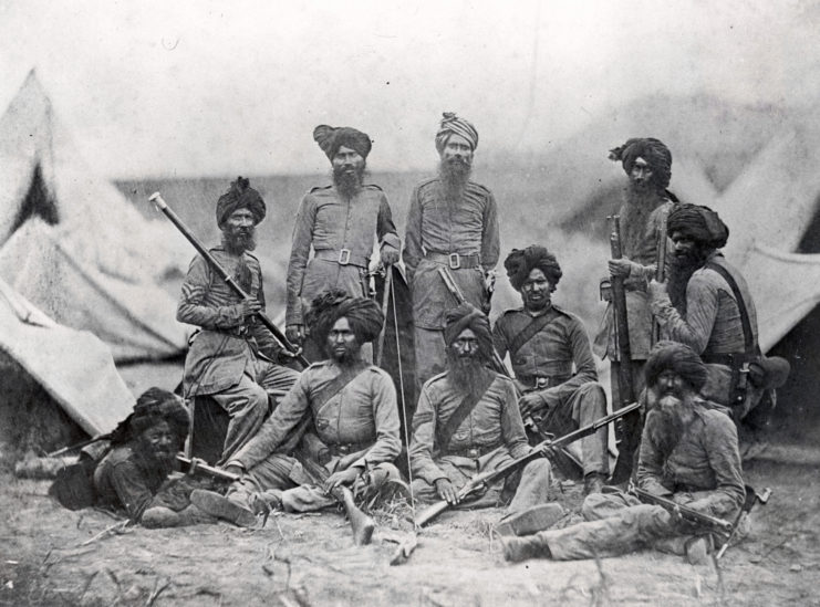 Sikh officers standing together in a makeshift camp