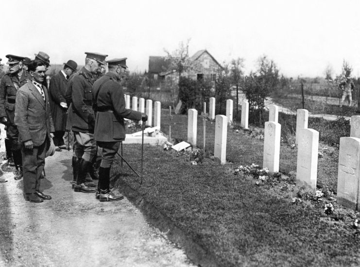 King George V, Douglas Haig and other military officials standing in front of British war graves