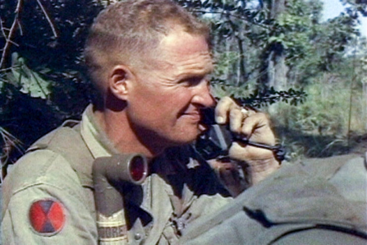 Hal Moore speaking on a telephone in the jungle