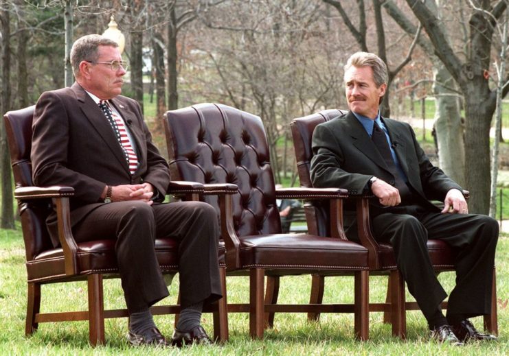 Hugh Thompson Jr. and Lawrence Colburn sitting in chairs outside