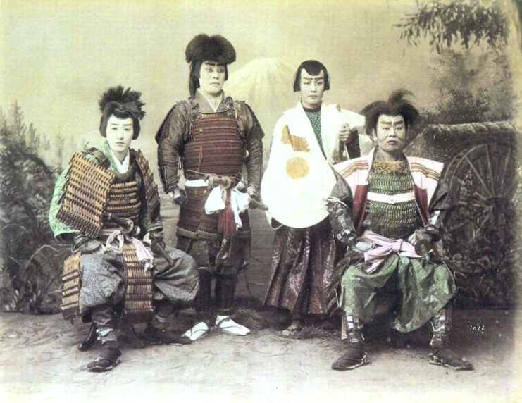 Four kabuki actors dressed as samurai