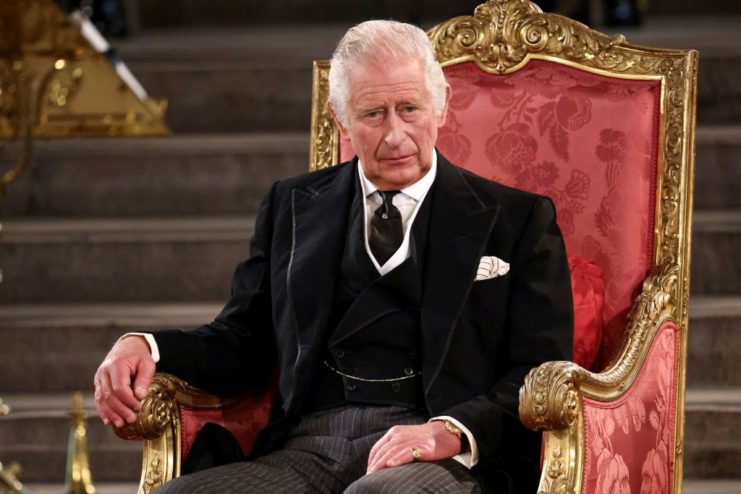 King Charles III sitting in a chair