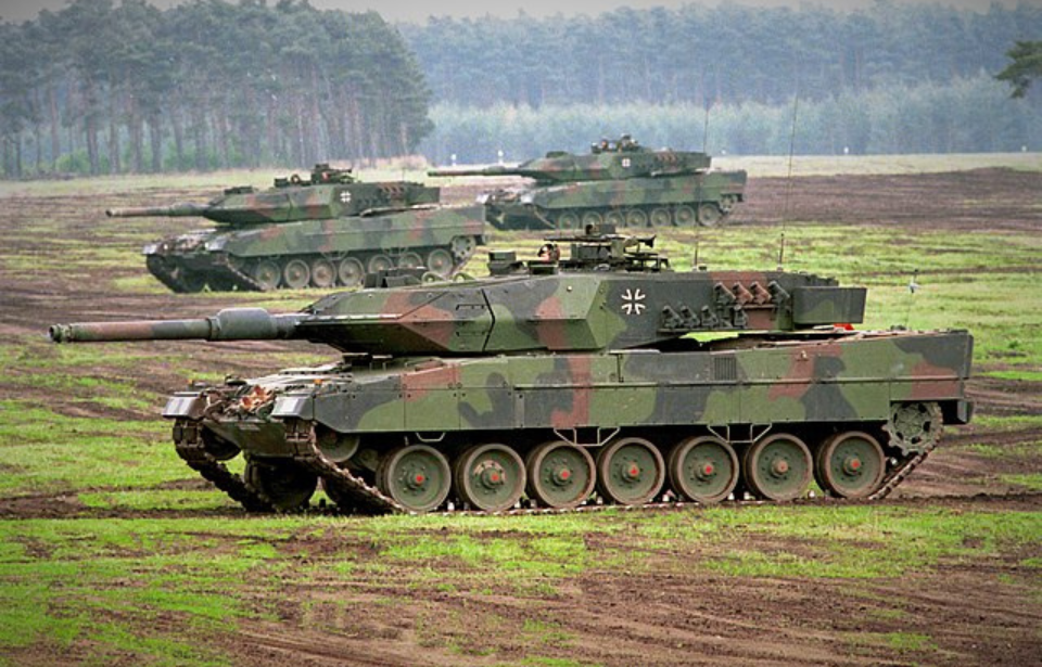 Three Leopard 2A5s parked in a field