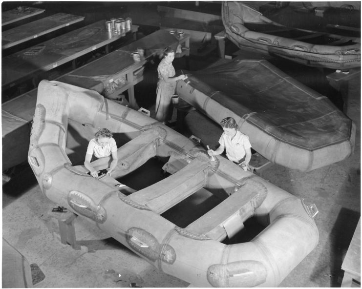 Three female workers constructing assault boats in a factory