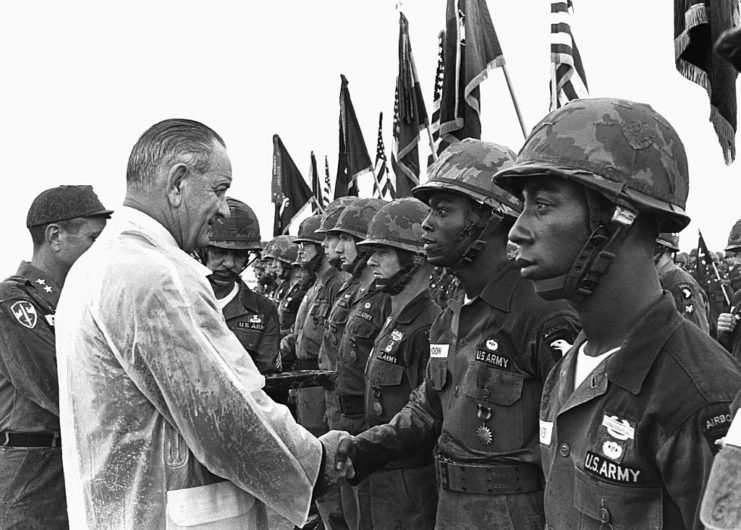 Lyndon B. Johnson shaking hands with soldiers