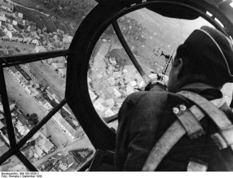 German air gunner manning a nose gun turret while his aircraft is in flight