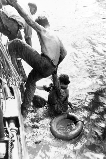 US Navy sailors being lifted out of the water
