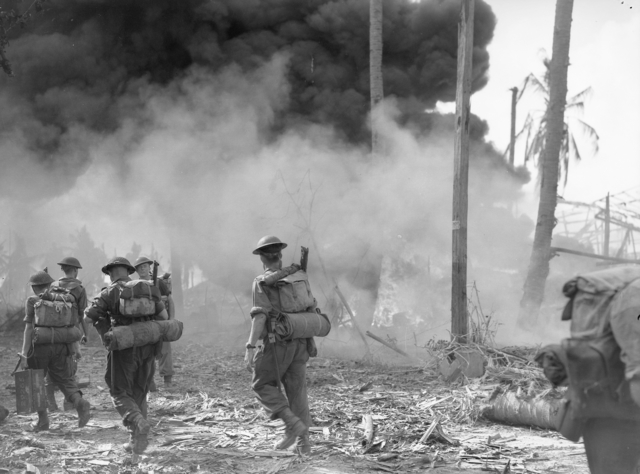 Members of 7th Division, Second Australian Imperial Force walking into smoke