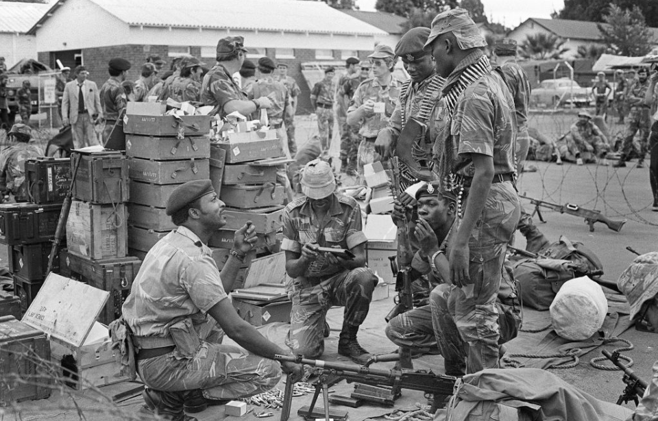 Members of the Rhodesian Security Forces gathered together at a camp