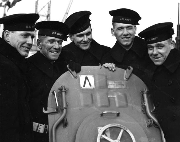 Sullivan Brothers standing around a hatch on the USS Juneau (CL-52)