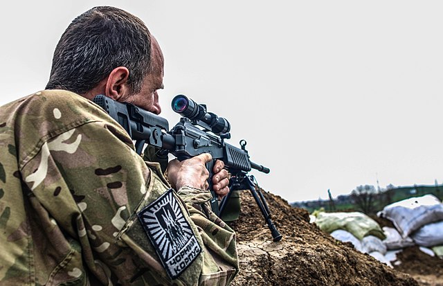 Ukrainian sniper aiming his rifle