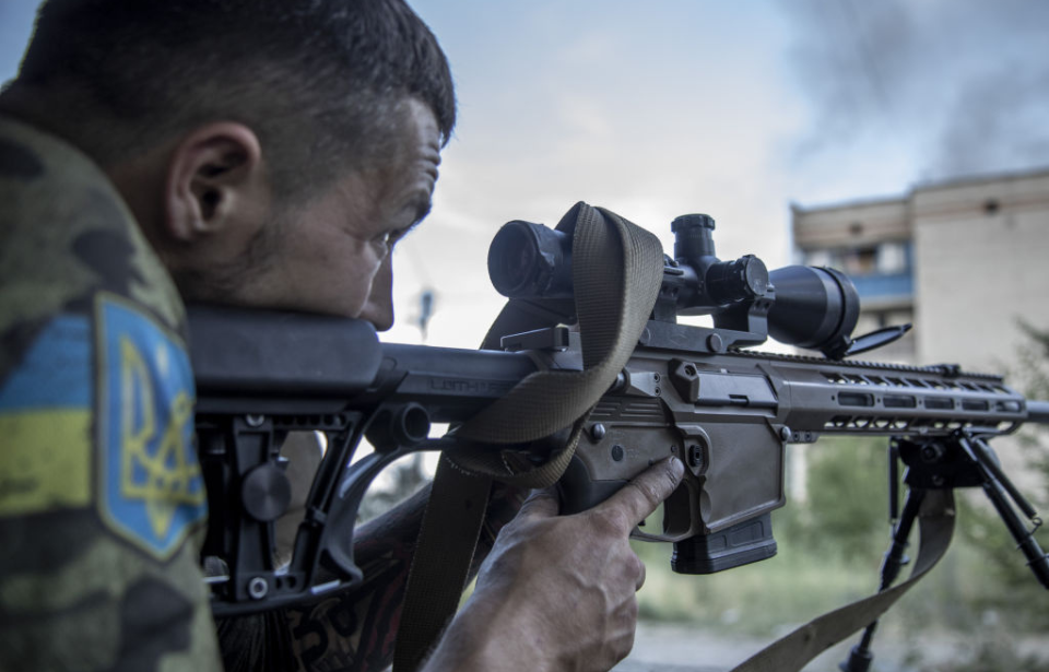Ukrainian sniper aiming his rifle