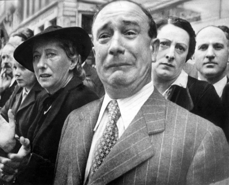 Weeping Frenchman standing in a crowd