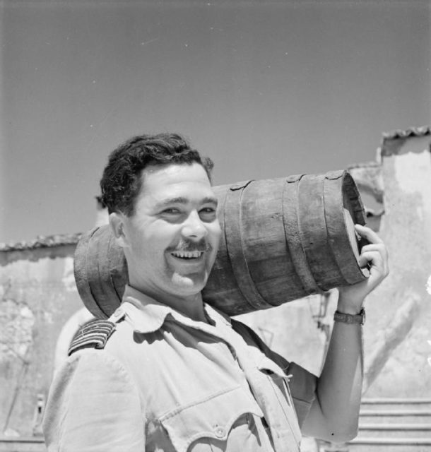 G.H. Westlake carrying a cask of wine