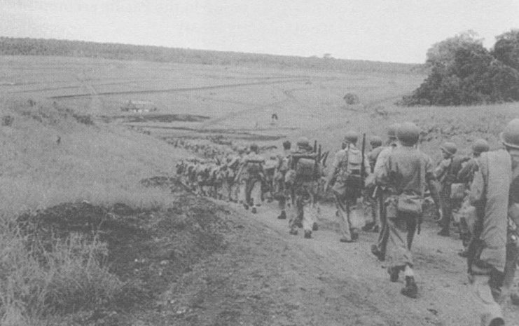 US Marines walking along a dirt road