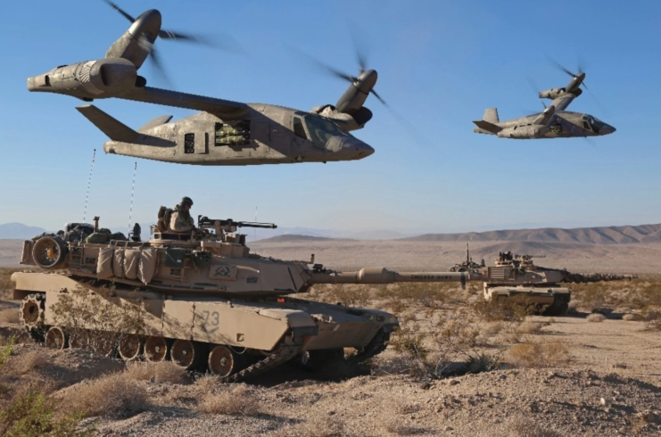Two Bell V-280 Valor tiltrotors hovering over tanks in the desert