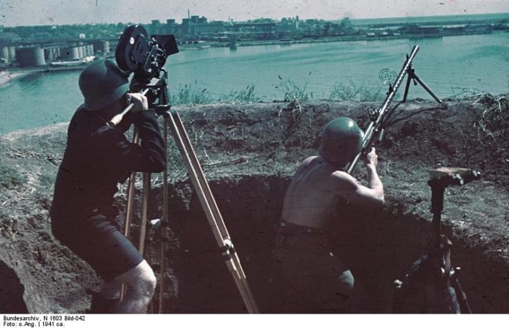 Cinematographer filming a German soldier firing an MG 13