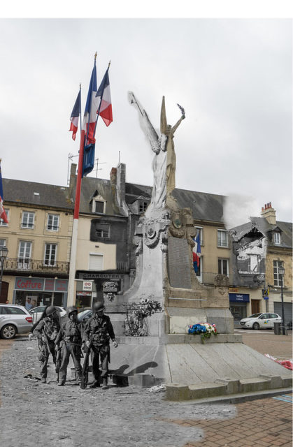 Soldiers standing in front of the Carentan Great War Memorial