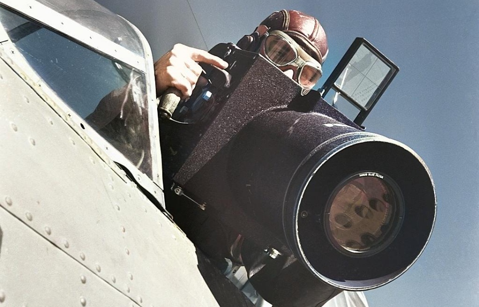 Aerial photographer holding a large camera