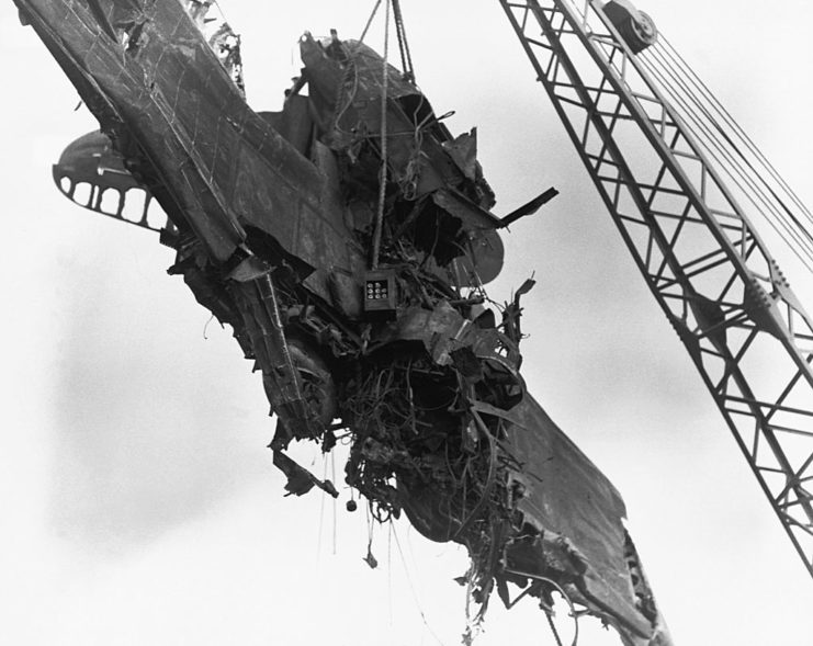 Crane lifting a damaged aircraft