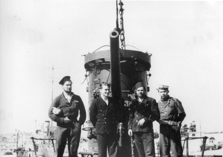 Four crewmen standing atop the ORP Dzik